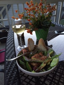 On the porch with a grilled salmon salad and Scholarship White from College Cellars.